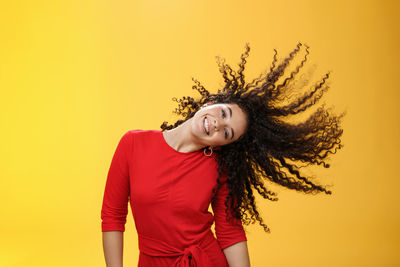 Smiling young woman against gray background