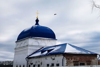 Low angle view of seagull on building against sky