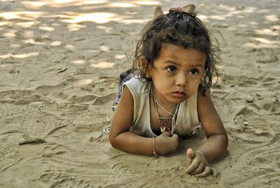 Portrait of boy on sand at beach