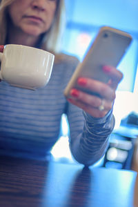 Close-up of woman holding coffee cup