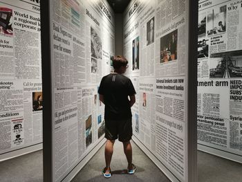 Rear view of man standing on paper