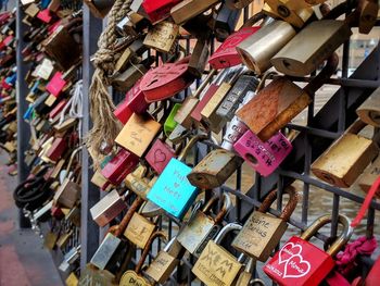 Close-up of padlocks hanging on railing