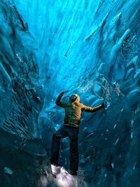 Man standing on rock in cave