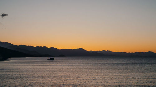 Scenic view of sea against clear sky during sunset