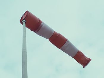 Low angle view of flags against sky