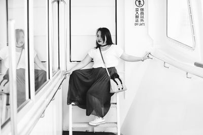 Thoughtful woman sitting on steps in boat