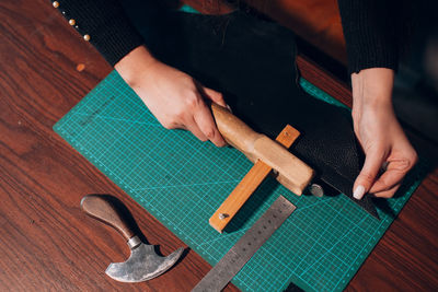 Cropped image of young fashion designer working at workshop