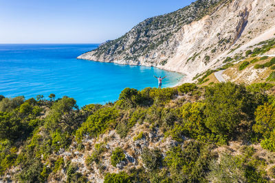 Scenic view of sea and mountains against sky