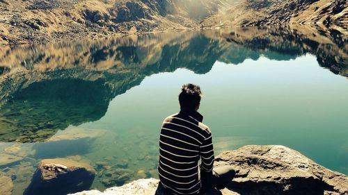 Silhouette of woman standing by lake