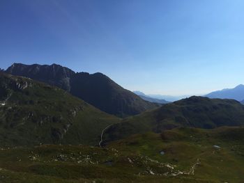 Scenic view of mountains against clear blue sky