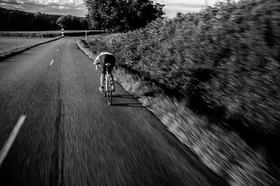 Man riding bicycle on road