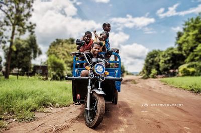 People riding motorcycle on road