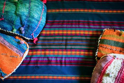High angle view of colorful pillows on bed