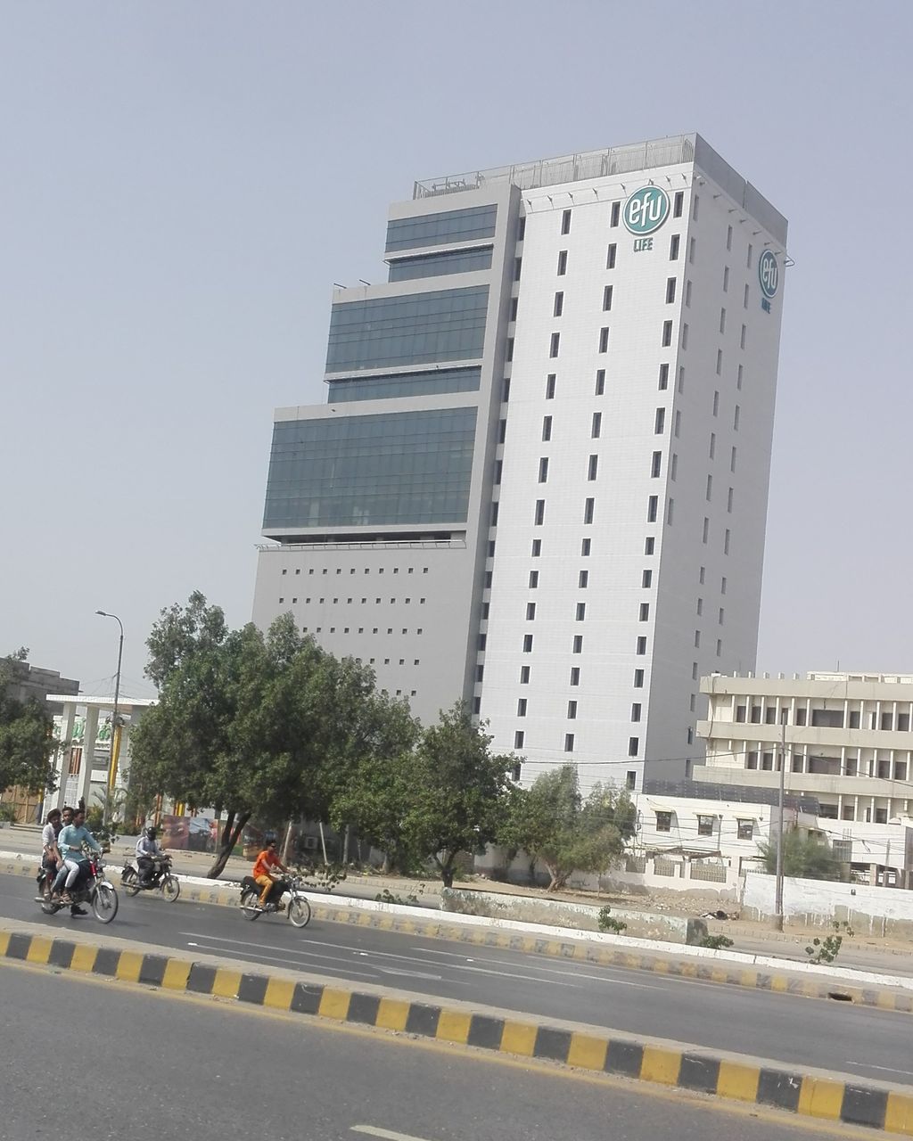 ROAD BY BUILDING AGAINST SKY