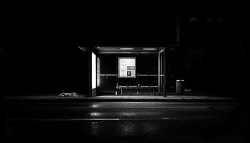 Empty illuminated building in city at night
