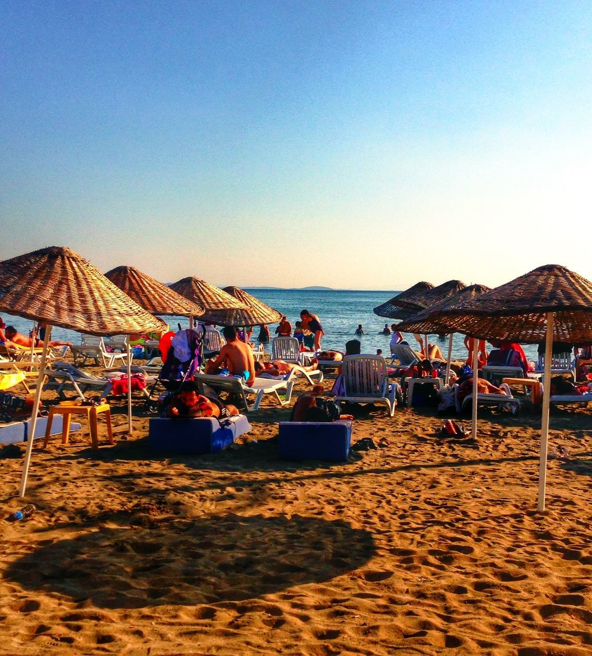 beach, sand, sea, clear sky, shore, beach umbrella, water, parasol, vacations, copy space, blue, lounge chair, sunshade, horizon over water, tranquil scene, tranquility, deck chair, scenics, summer, thatched roof