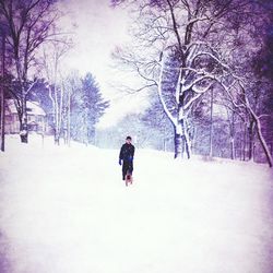 Woman standing on snow covered landscape