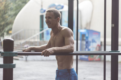 Side view of man exercising in gym
