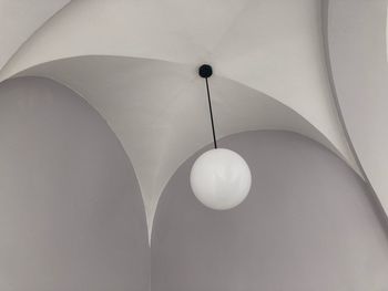 Low angle view of illuminated pendant light hanging from ceiling