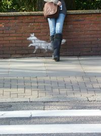 Low section of woman standing on tiled floor