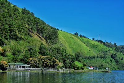 Beautiful view of lake toba with clear blue sky and green hills