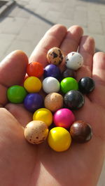 Cropped image of hand holding colorful candies