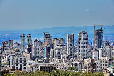 Modern buildings in city against sky