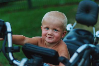 Portrait of cute boy riding bicycle