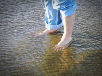 Low section of woman in water