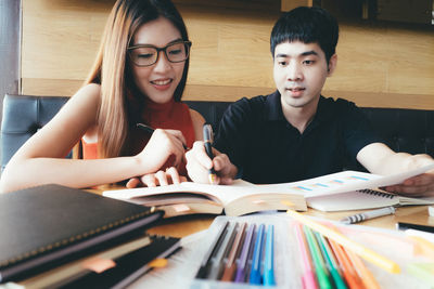 Young couple sitting on table