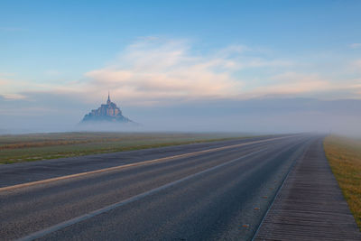 View of road against cloudy sky