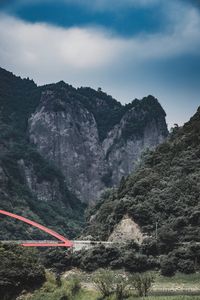 Scenic view of land and mountains against sky