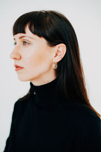 Close-up portrait of a beautiful young woman over white background