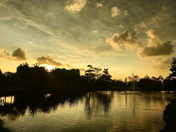 Scenic view of lake against sky at sunset