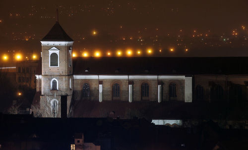 Illuminated building against sky at night