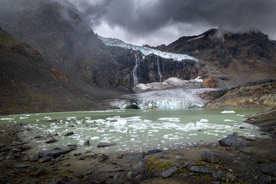 Scenic view of lake and mountains against sky