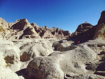 Scenic view of badlands national park against clear blue sky