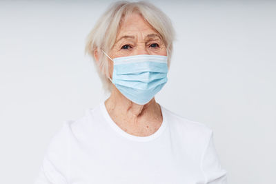 Portrait of man wearing mask against white background