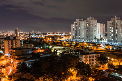 High angle view of illuminated buildings against sky at night