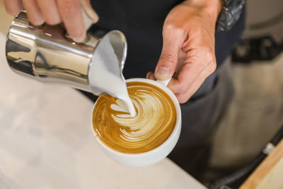 Midsection of woman with coffee cup