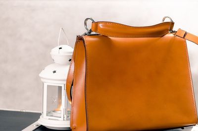 Close-up of bag and lantern on table