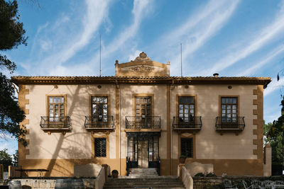 Low angle view of building against cloudy sky