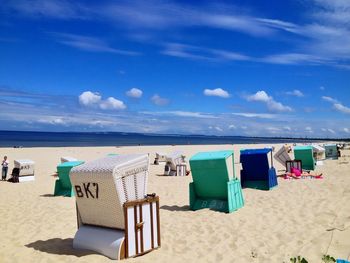 Scenic view of beach against cloudy sky