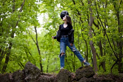 Rear view of woman standing on rock