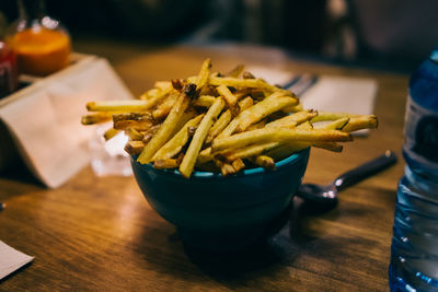 Close-up of french fries in bowl on table