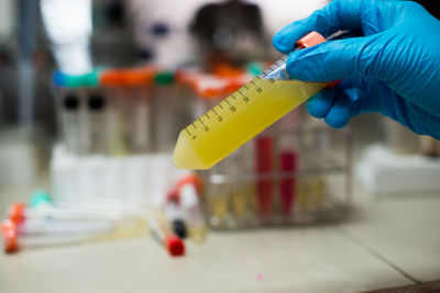 Cropped hand examining in laboratory