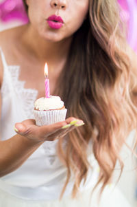 Midsection of woman holding ice cream