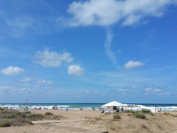 View of beach against cloudy sky