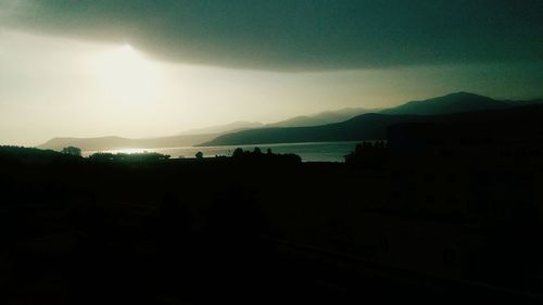 Scenic view of silhouette mountains against sky during sunset