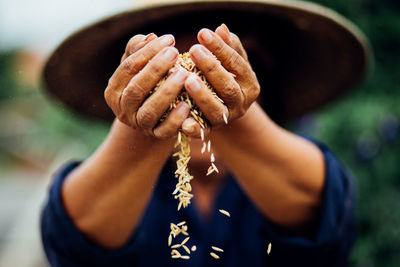 Close-up of farmer holding wheat